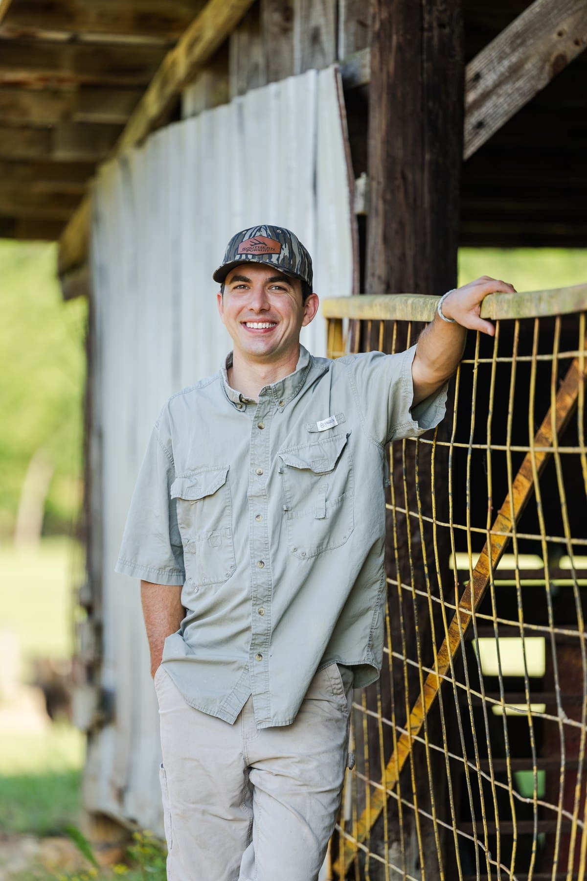 Jesse leaning on a gate at the family farm
