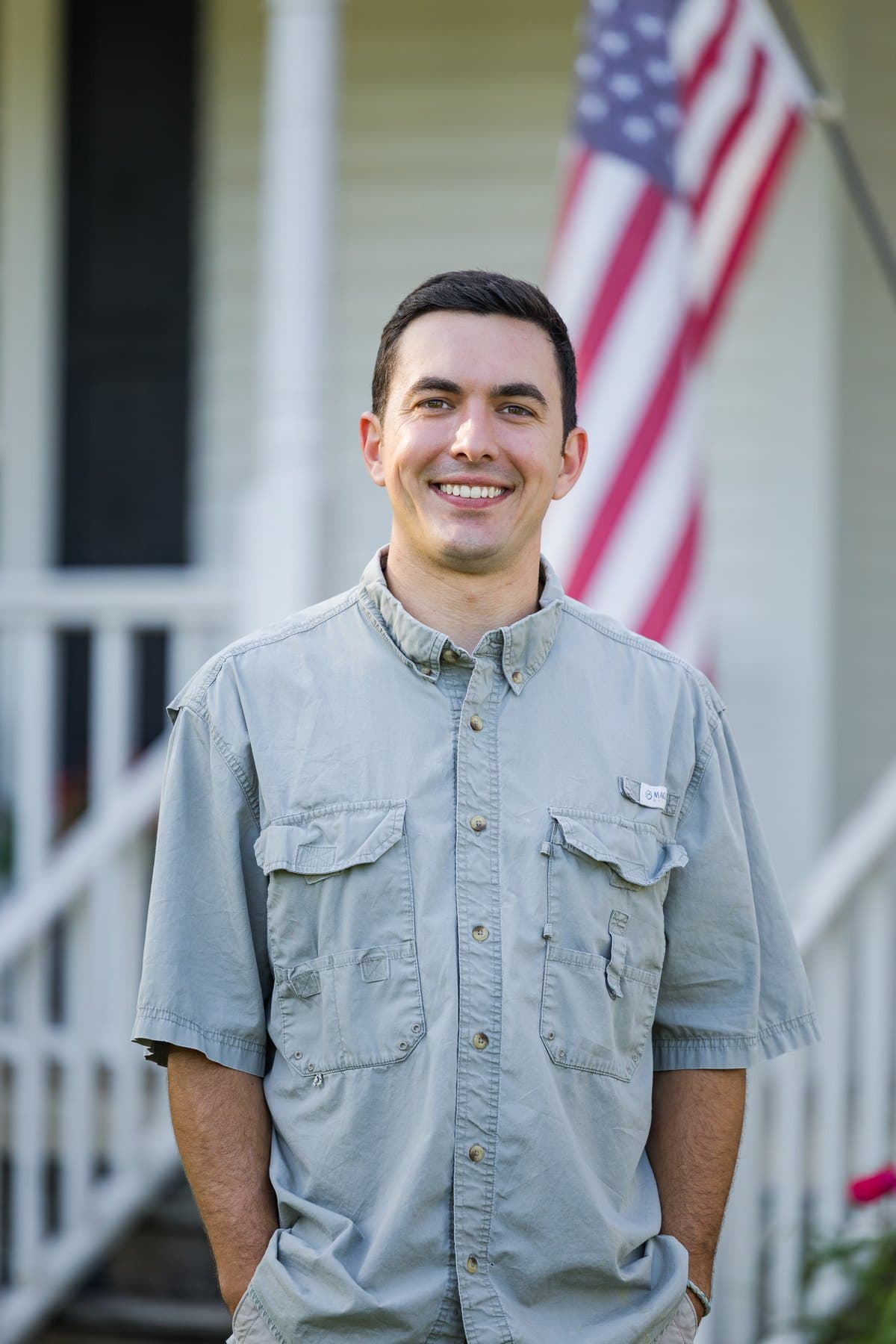 Jesse on the front porch with an American flag